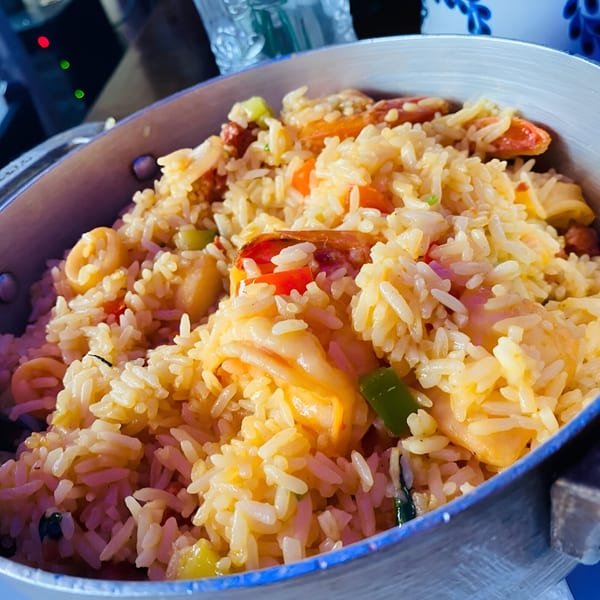 Close-up of Peruvian arroz con mariscos, a seafood rice dish with shrimp, squid, and vegetables.